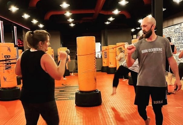 coach boxing with woman